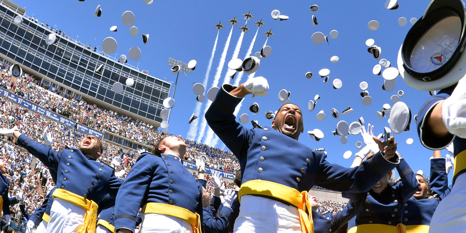 Image of graduation ceremony with Thunderbird flyover.
