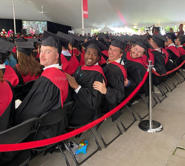 1st Lt. Coen Williams (left) sits with his classmates during graduation from Harvard Kennedy School of Government