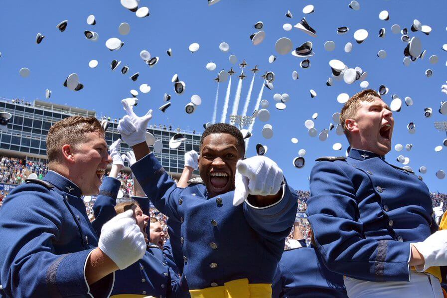 Three cadets at graduation at stadium