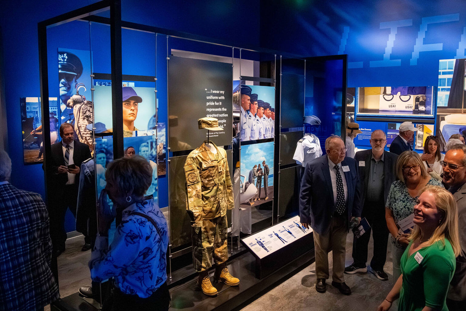 U.S. Air Force Academy alumni and their families tour the Hosmer Visitor Center following the Hosmer Visitor Center ribbon cutting May 15, 2026. The new facility features immersive exhibits that highlight cadet life, Academy traditions and the 47-month journey from basic cadet to commissioning. (U.S. Air Force Photo by Trevor Cokley)