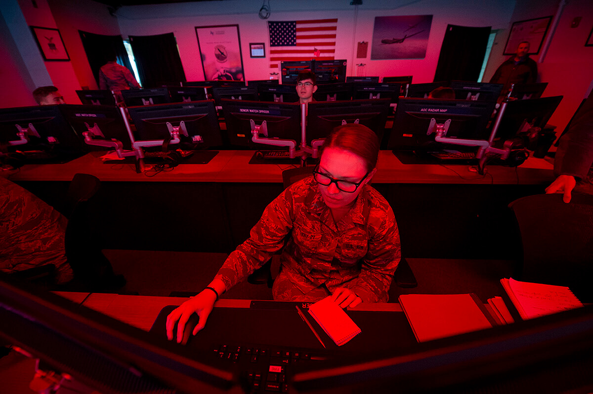 Cadets in room with red lighting