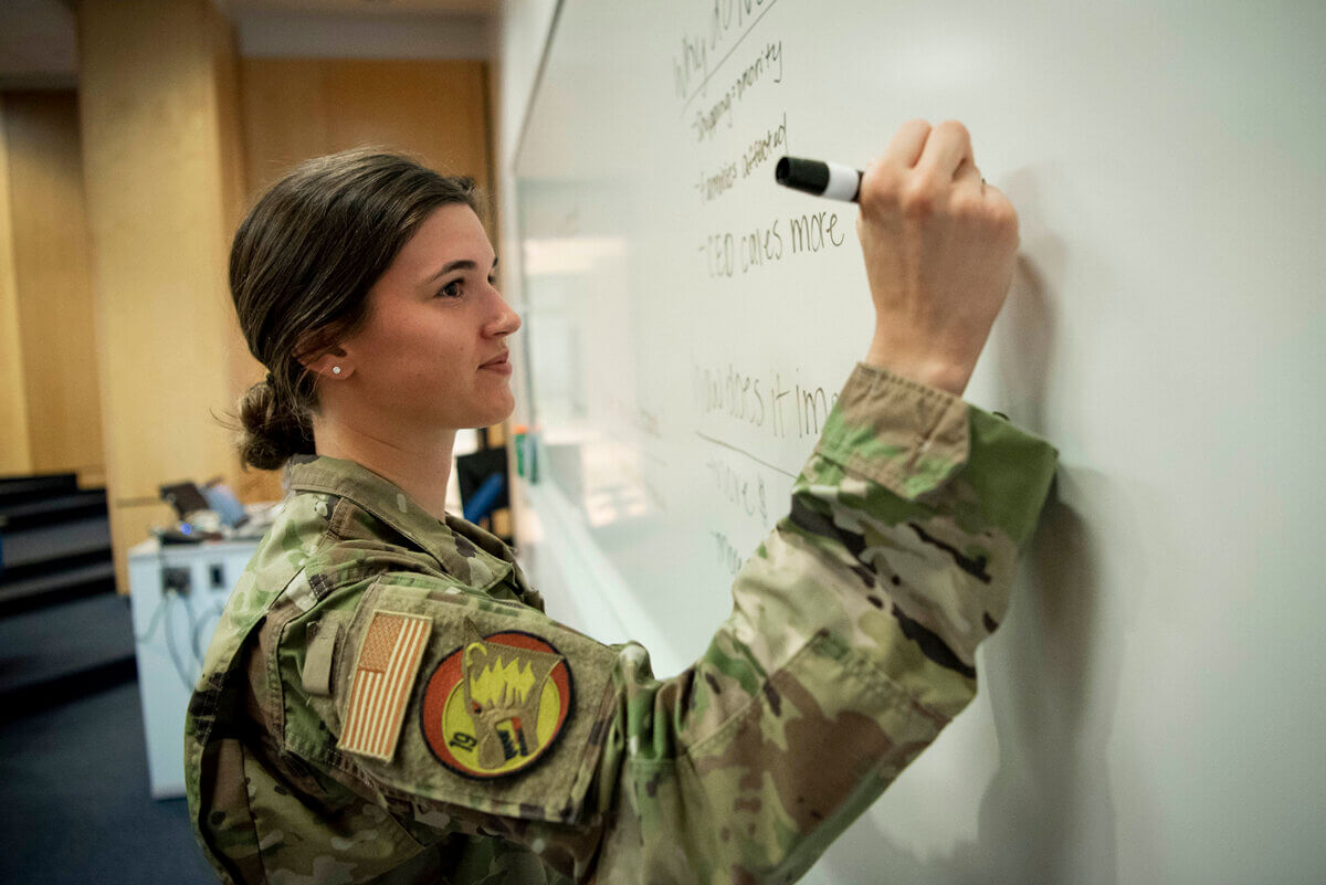 cadet writing on whiteboard promoting the Summer Innovation course