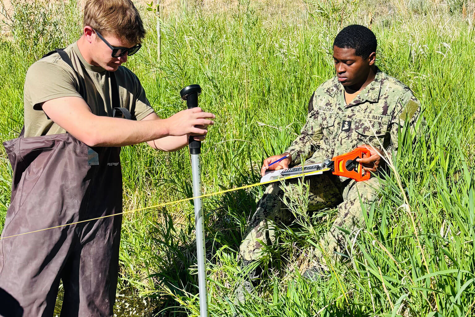 Cadet 2nd Class Jonah Meyer measures stream velocity while Midshipmen Peyton Guilory records field data during a CivEngr 351 Civil Engineering Practices exercise at the U.S. Air Force Academy, June 16, 2026. As part of water resources field operations, cadets collect and analyze hydraulic measurements in a natural stream to develop the engineering judgment needed to assess water resources, infrastructure performance and environmental conditions. (Courtesy photo by Lt. Col. Kathleen Smits)