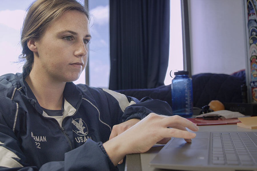 Image of cadet studying on a laptop.