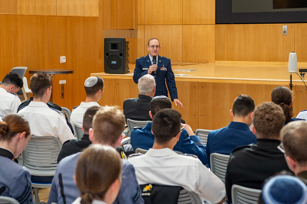 A speaker talking to Cadets and Midshipmen at the Jewish Warrior Weekend.