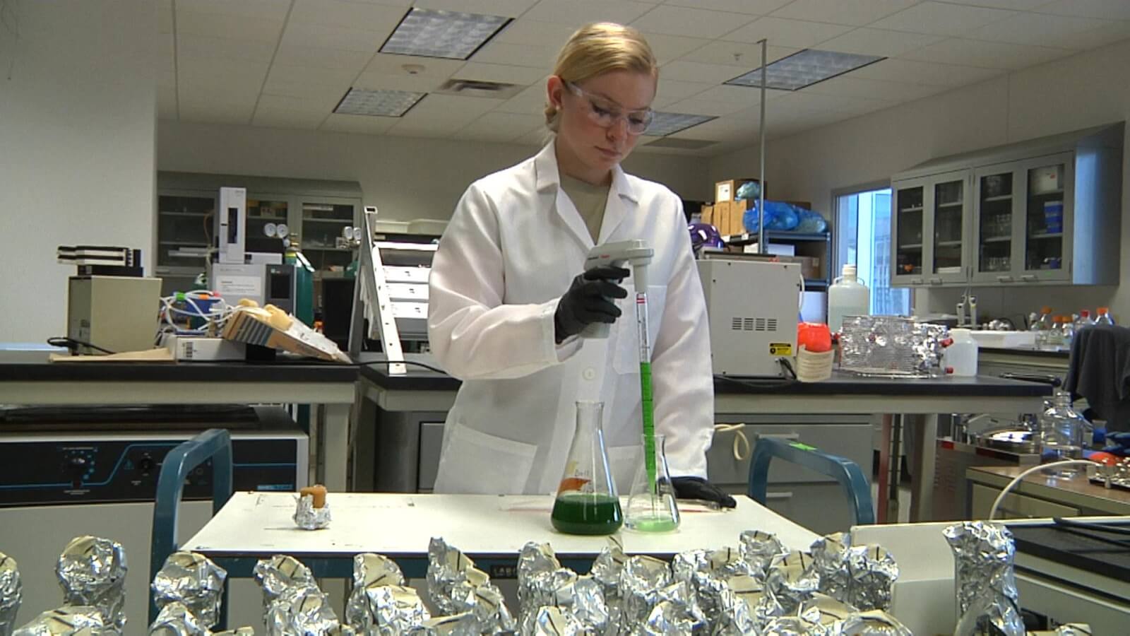 Cadet testing a solution in a flask.