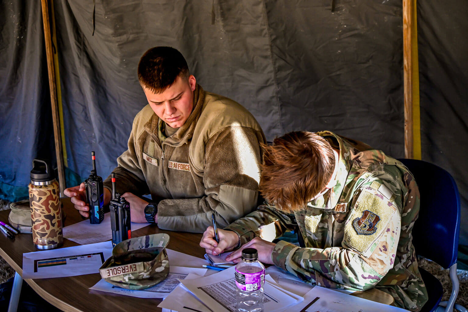 Cadet candidates Dawson Amick (left) and Jay Eversole take command of their squadron’s tactical operations center during a Silver Saturday training exercise, at the U.S. Air Force Academy Preparatory School, Colorado, Jan. 31, 2026. The exercise focused on coordinating movements and keeping the operation running seamlessly. (U.S. Air Force Photo by C/C Madison Harte)
