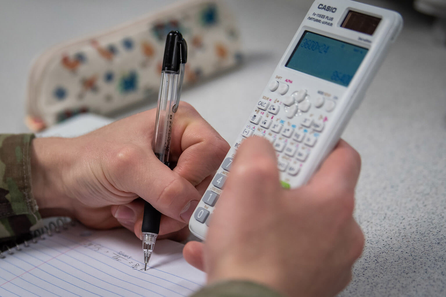 hands holding calculator