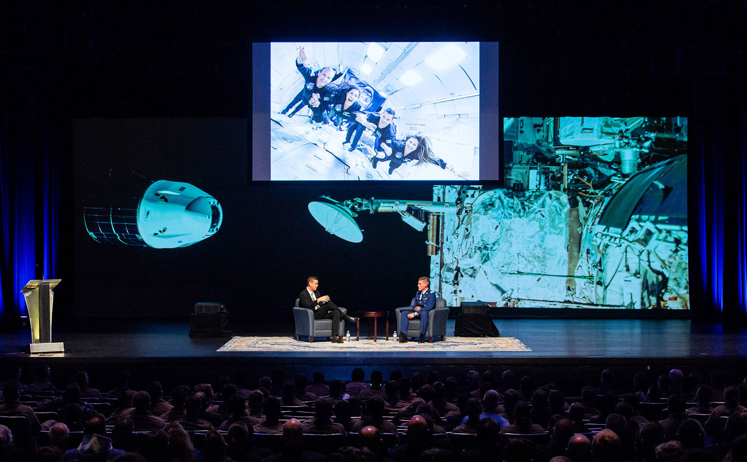 Jared Isaacman speaks with Cadet 1st Class Garrett Greenwood on stage at Arnold Hall