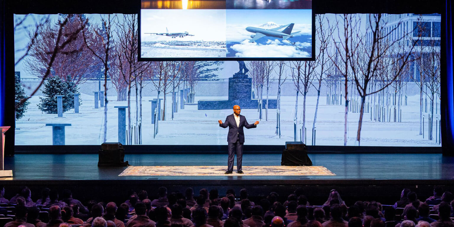 A speaker talks to a large audience during an NCLS event.