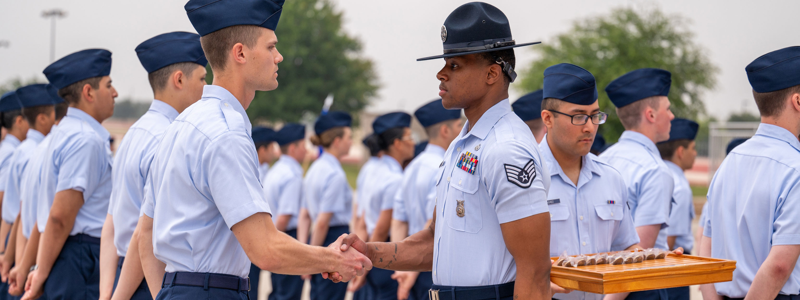Graduating Air Force Airmen during a ceremonial event marking the completion of basic military training.