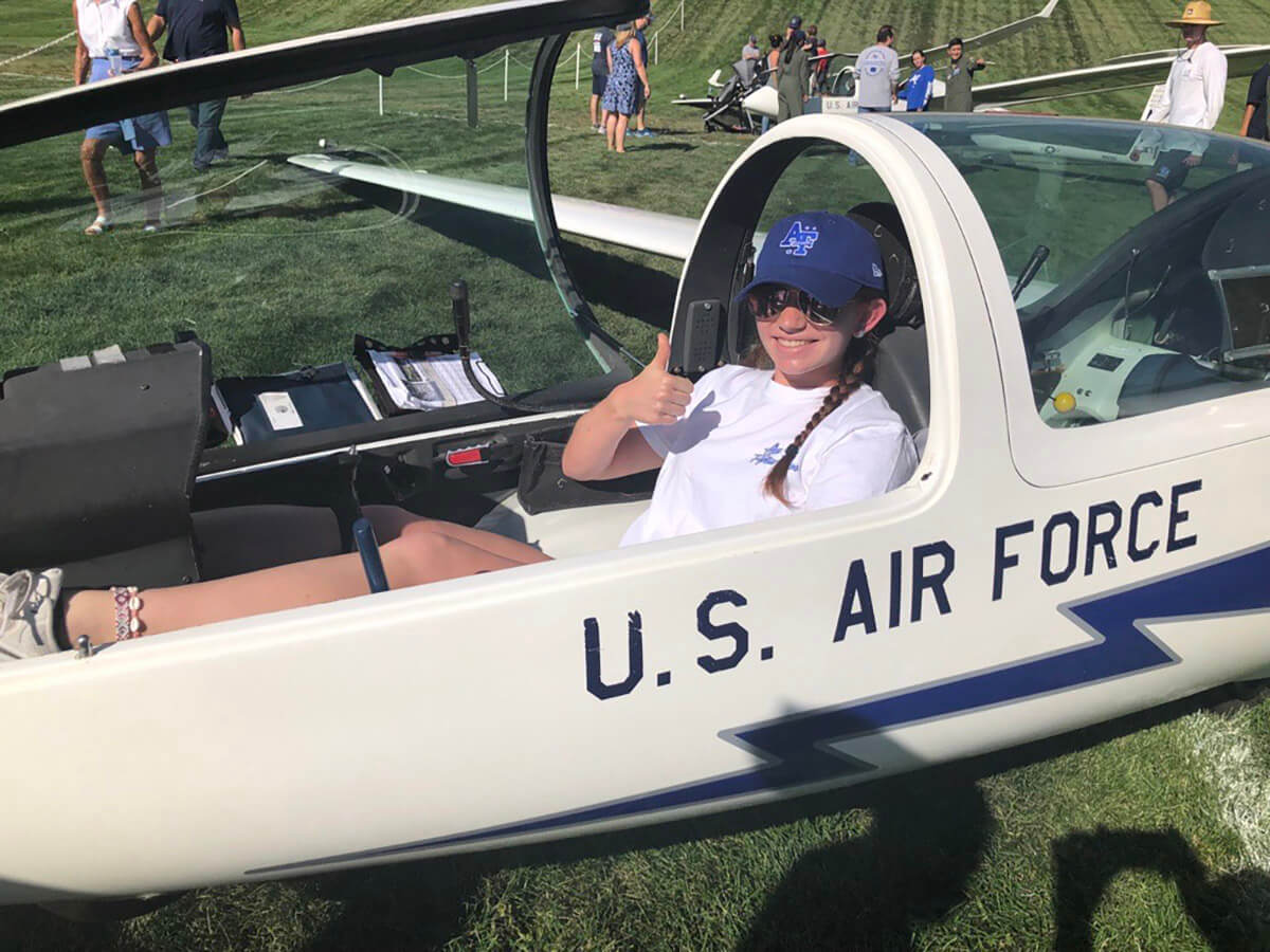 Riley Glenn sits in a soaring program glider