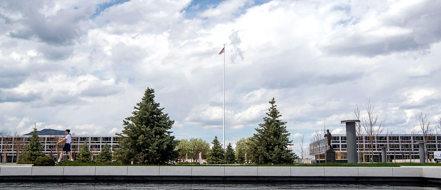 Cadet walking past reflection pool