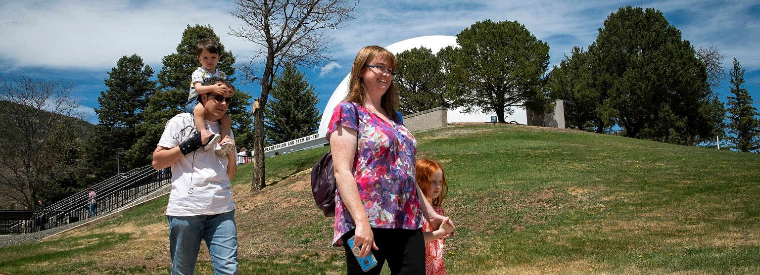 family in front of planetarium, top Academy experiences