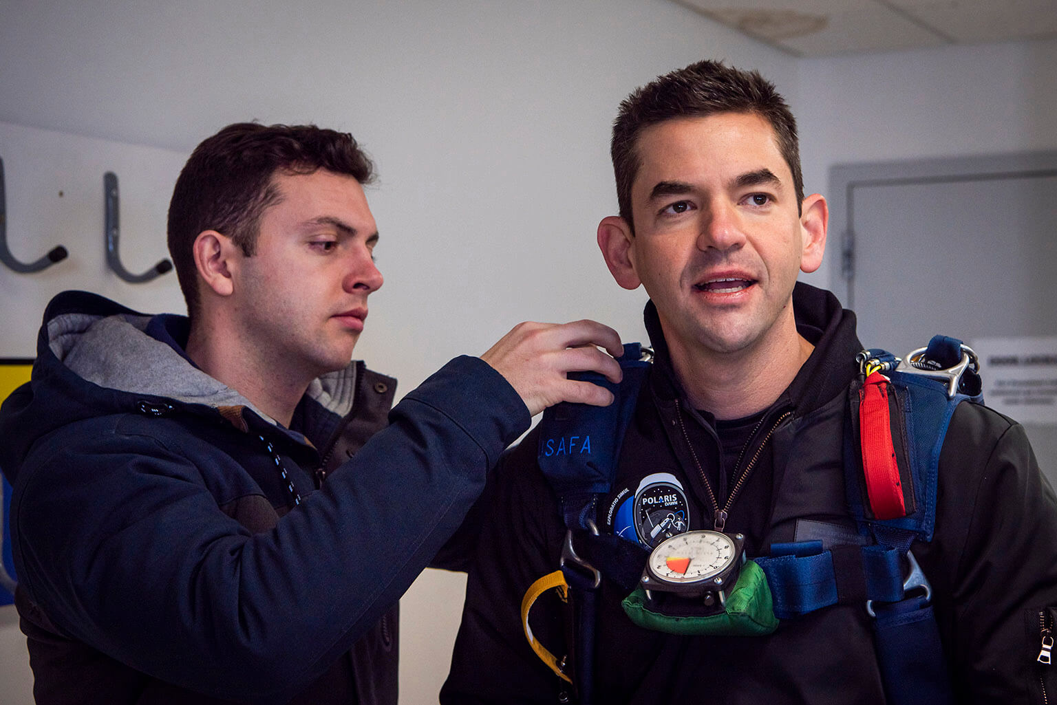 2nd Lt. Jack Dillon conducts an initial gear check for Jared Isaacman,