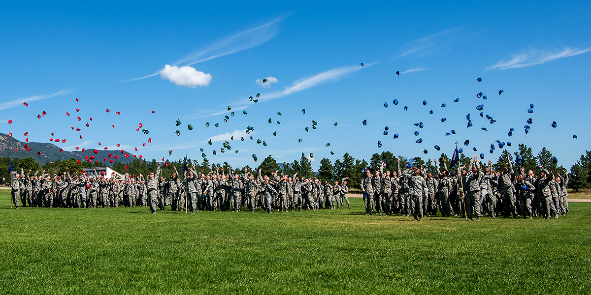 Image of cadet candidates celebrating during graduation parade.
