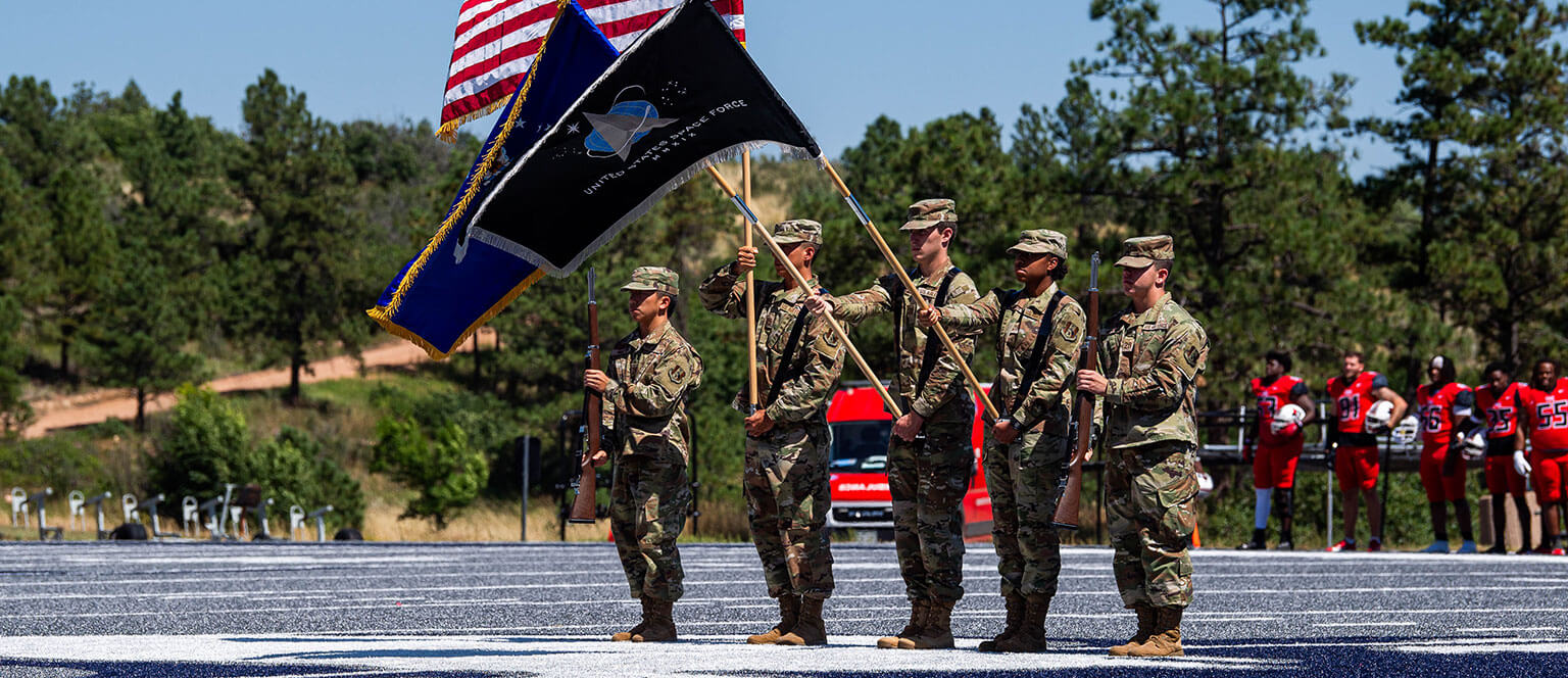 Cadet candidates performing in an honor guard display.