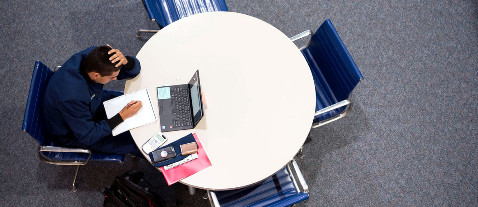 Image of a cadet working at a table.