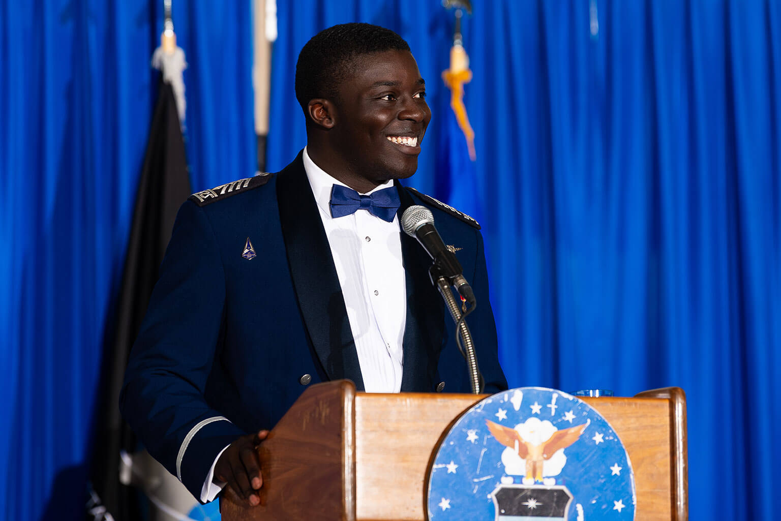 Cadet 2nd Class Kobe Achu, Class of 2026 president, at the lectern during the Class of 2026 Ring Dance, in Mitchell Hall.