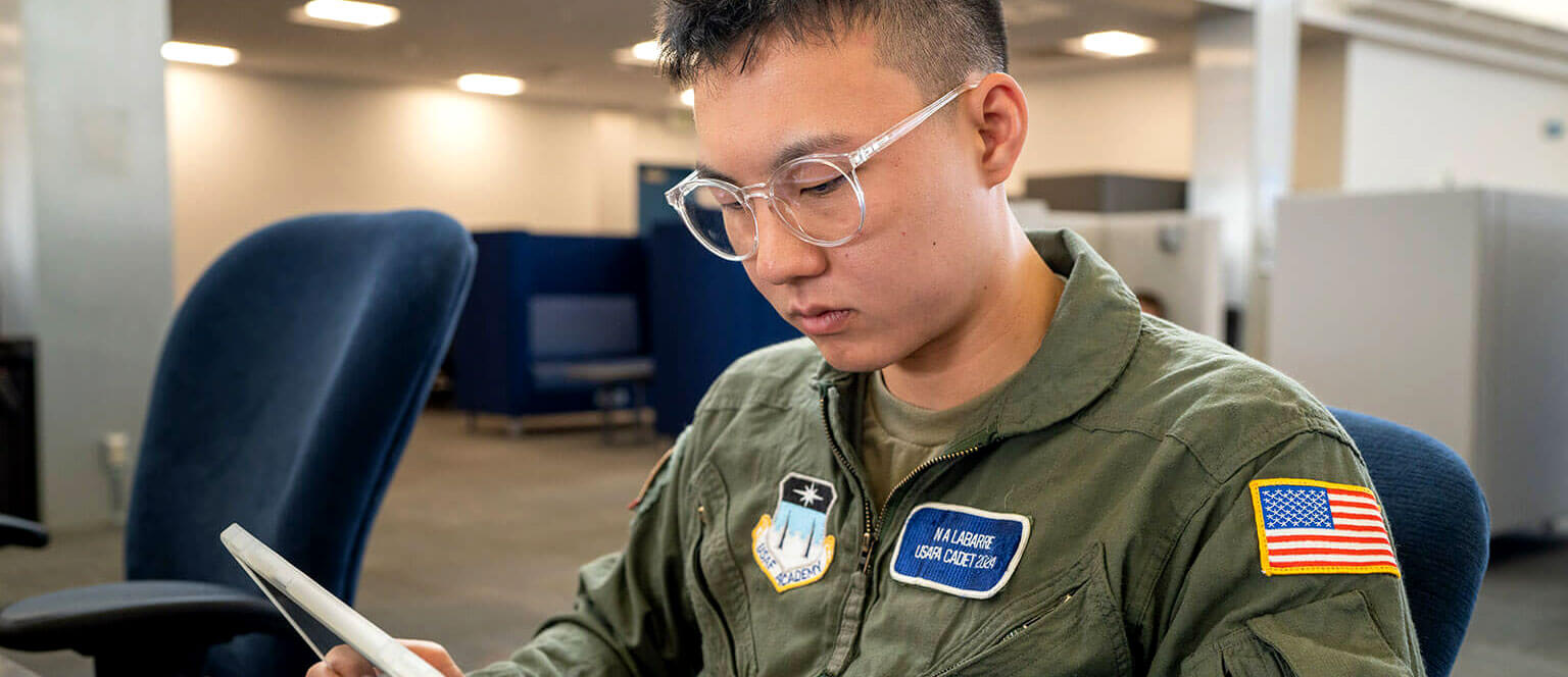 Cadet studying on a tablet.