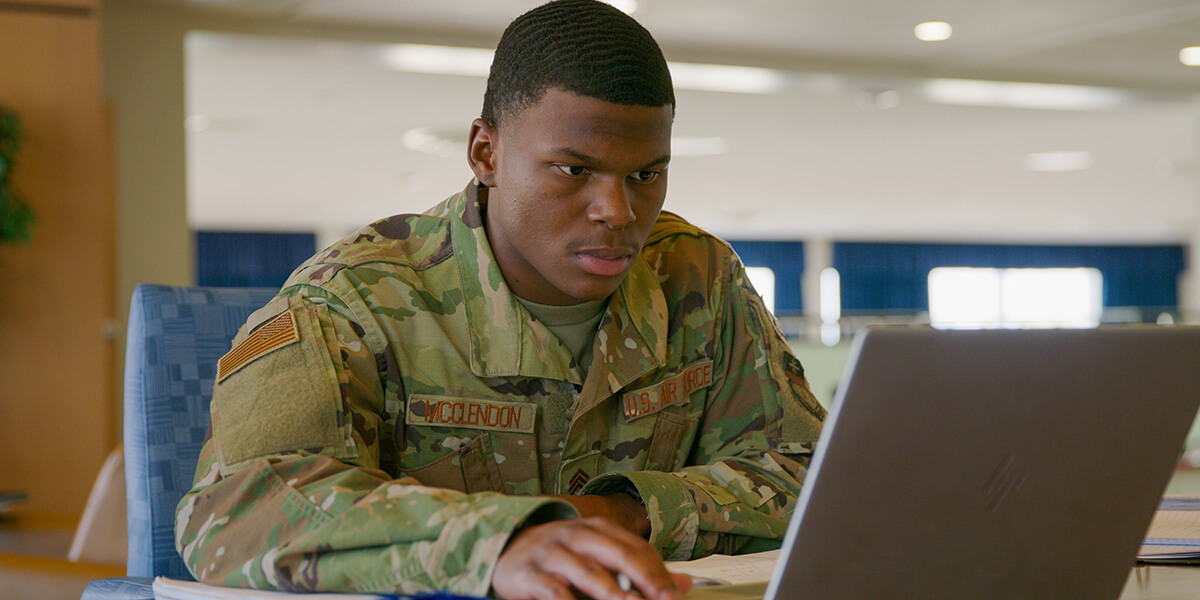 Image of a cadet studying on a computer.
