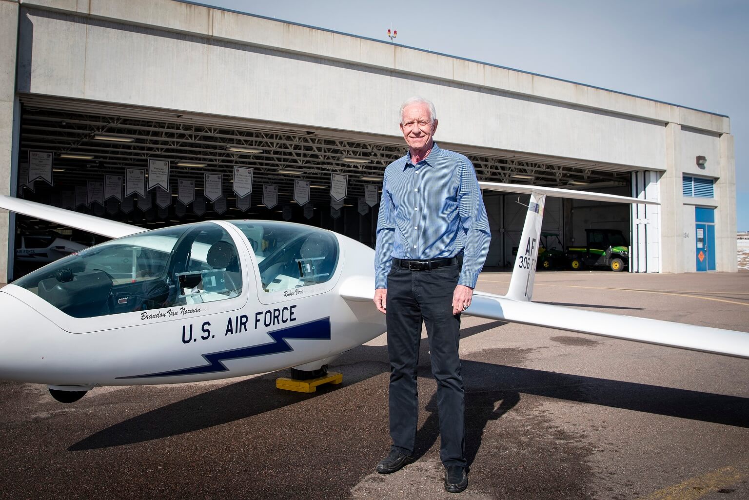 Sullenberger stands in front of an Air Force Academy glider at the Davis Airfield.