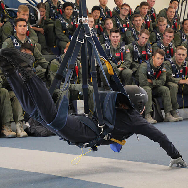 Instructor suspended in harness.