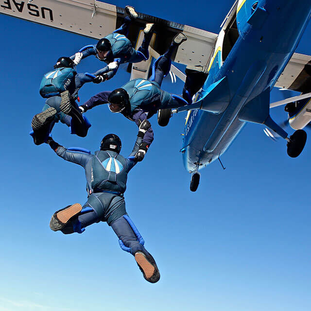 Wings of Blue members jumping out of plane