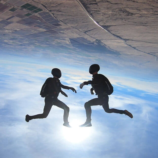 Two competition team members doing moves during skydive