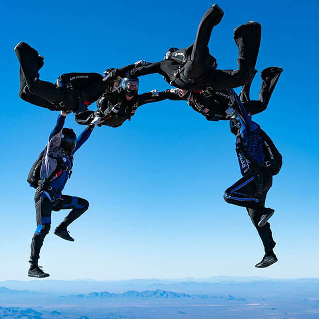 Six competition team members doing aerial trick