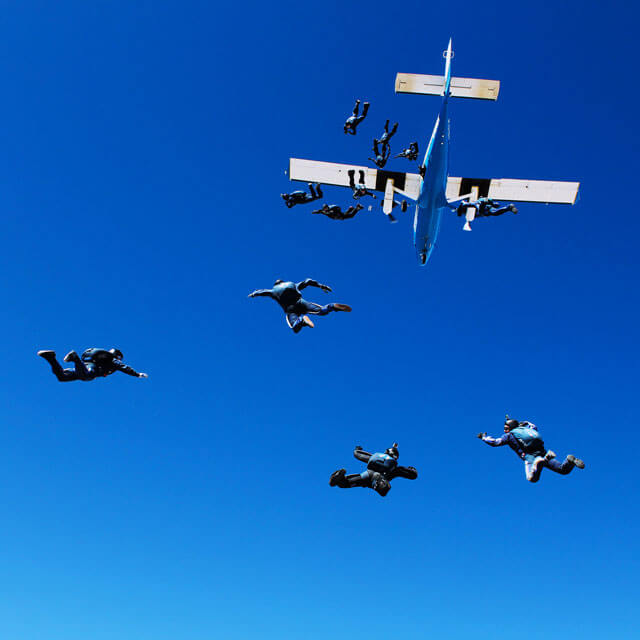 Competition team members jumping out of plane