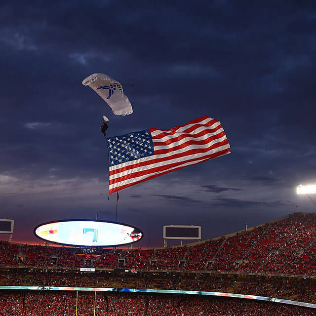 Wings of Blue member trailing flag into Arrowhead Stadium during KC Chiefs game