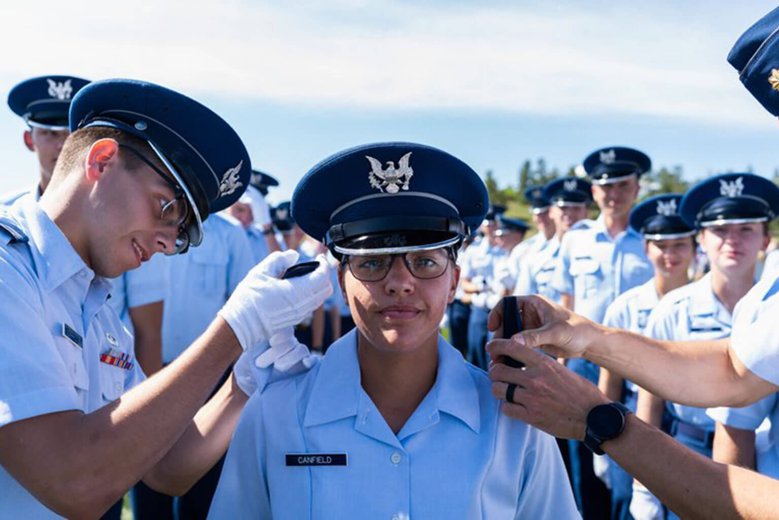 Cadet Fourth Class Elizabeth Canfield receives her shoulder boards during the Acceptance Day Parade at the U.S. Air Force Academy's Stillman Field in Colorado Springs, Colo., on Aug. 5, 2022. The ceremony marks a cadet's official entry into the Cadet Wing after completing basic training. (Photo courtesy of Elizabeth Canfield)