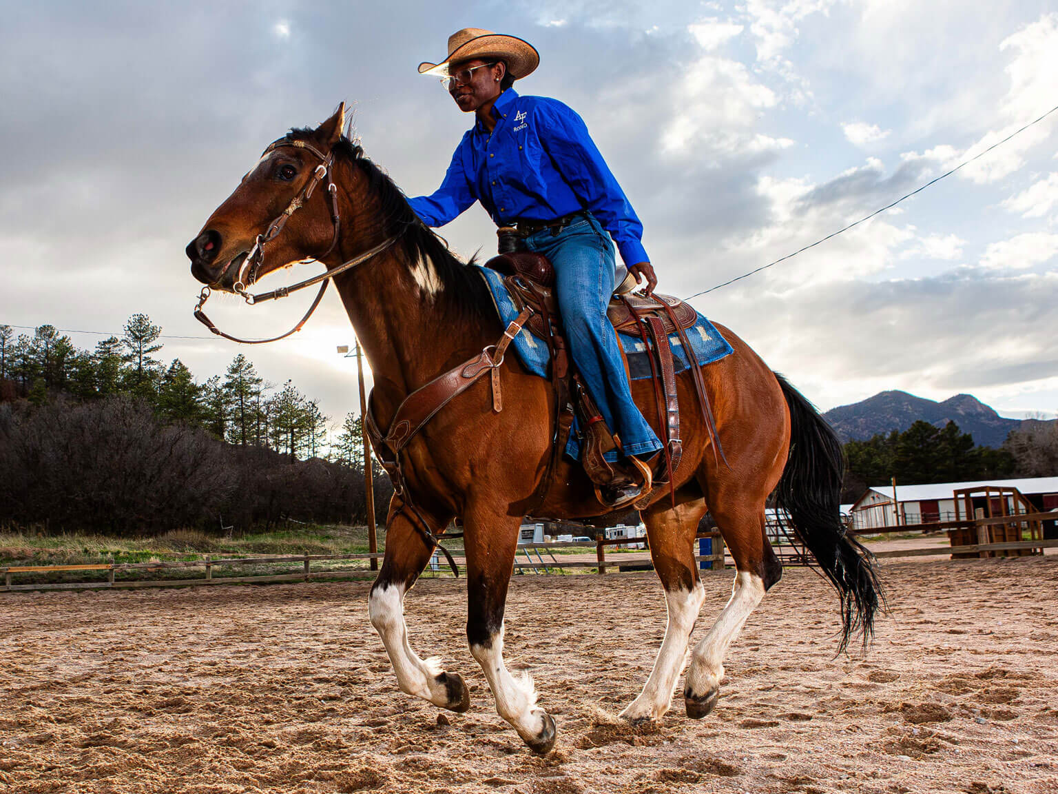 Cadet 3rd Class Lauryn Mitchell sits on the U.S. Air Force Academy Rodeo Club horse, Rebel, in the arena.