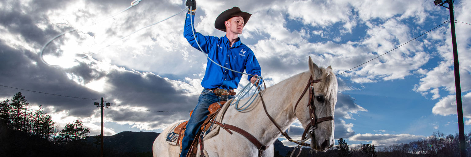 Cadet 1st Class Robert Ball poses with his horse, Ferg, out of the U.S. Air Force Academy Rodeo Club barn.