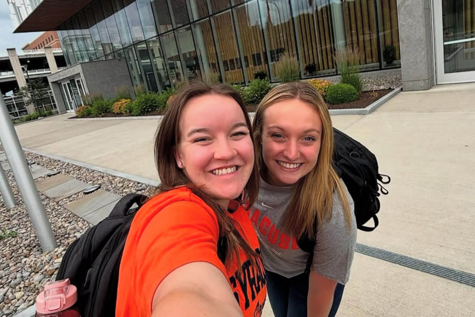 Cadet 1st Class Scarlet Nation, left, and Cadet 2nd Class Sophie Kent, right, take a selfie outside the D’Aniello Institute for Veterans and Military Families at Syracuse University building, Syracuse, New York