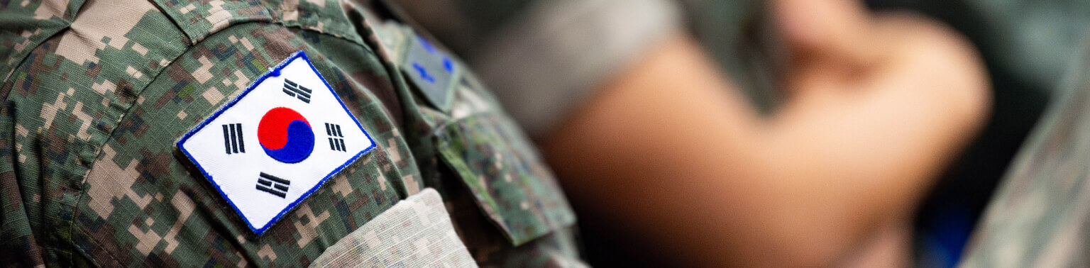 Close-up of an international cadet's military uniform with a South Korean flag patch on the shoulder.