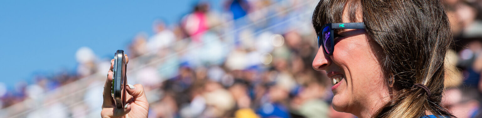 Parent watching and taking photo during the U.S. Air Force Academy's Parents' Weekend.