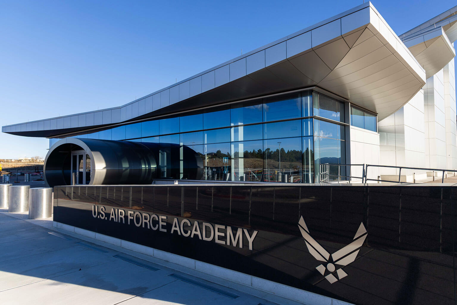 Exterior view of the Hosmer Visitor Center at the U.S. Air Force Academy at night.
