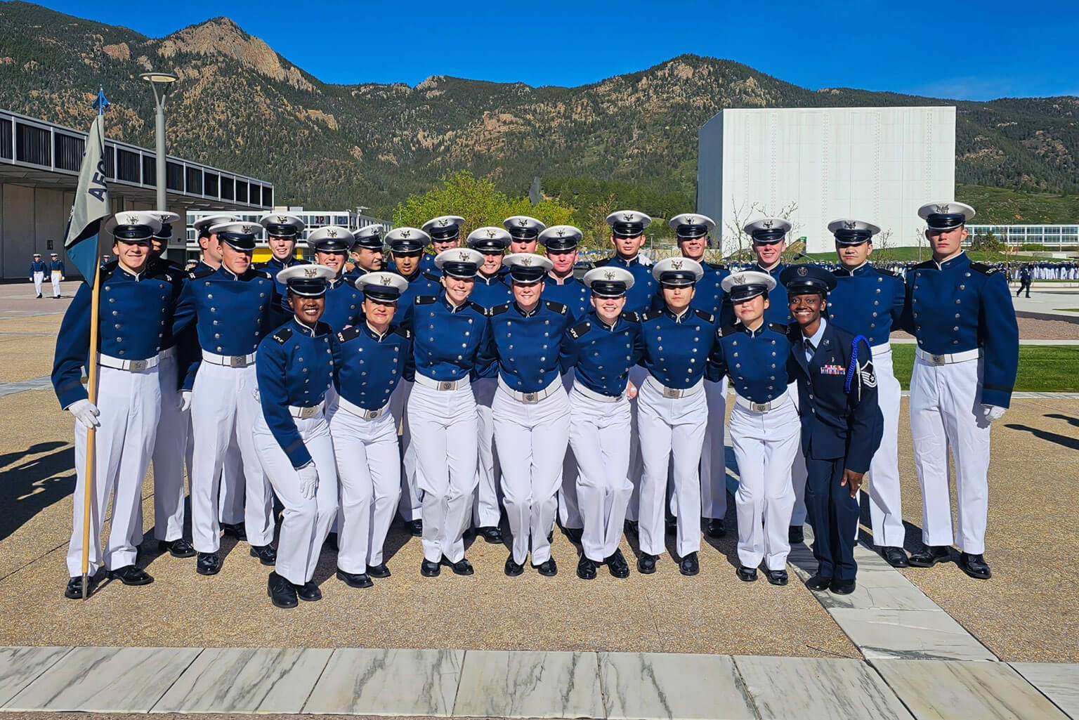 U.S. Air Force Master Sgt. Kimberly Kouete, Cadet Squadron 38 Academy Military Trainer, poses for a photo with her cadet squadron on the Terrazzo before the Founders’ Day Parade.