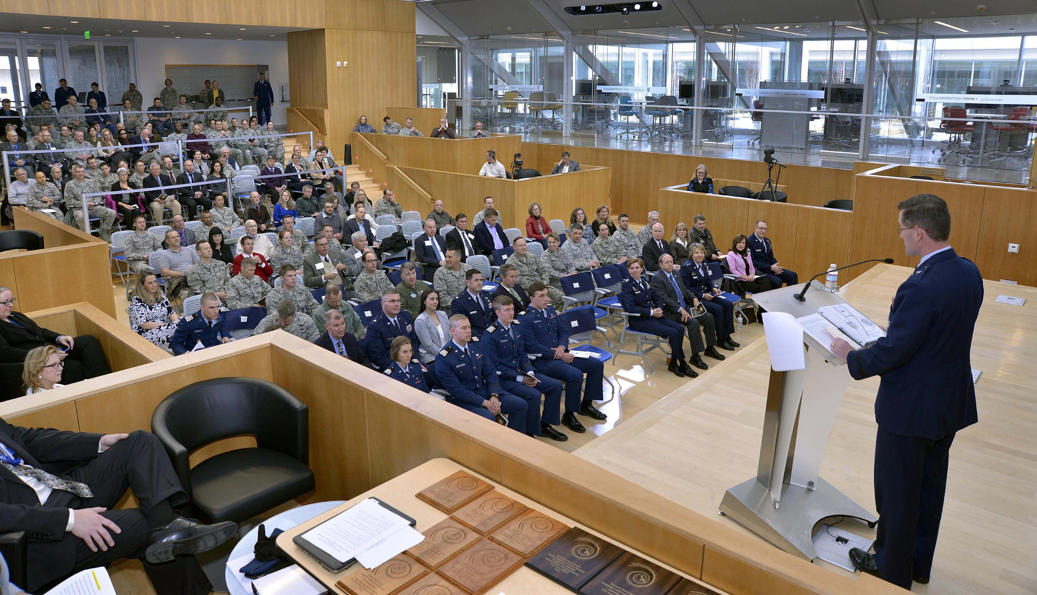 Brig. Gen. Andrew Armacost, the dean of the faculty, speaks from the stage of Polaris Hall