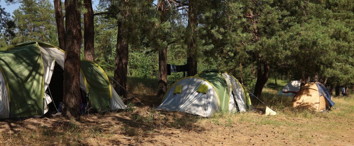 Camping area with tents on summer day