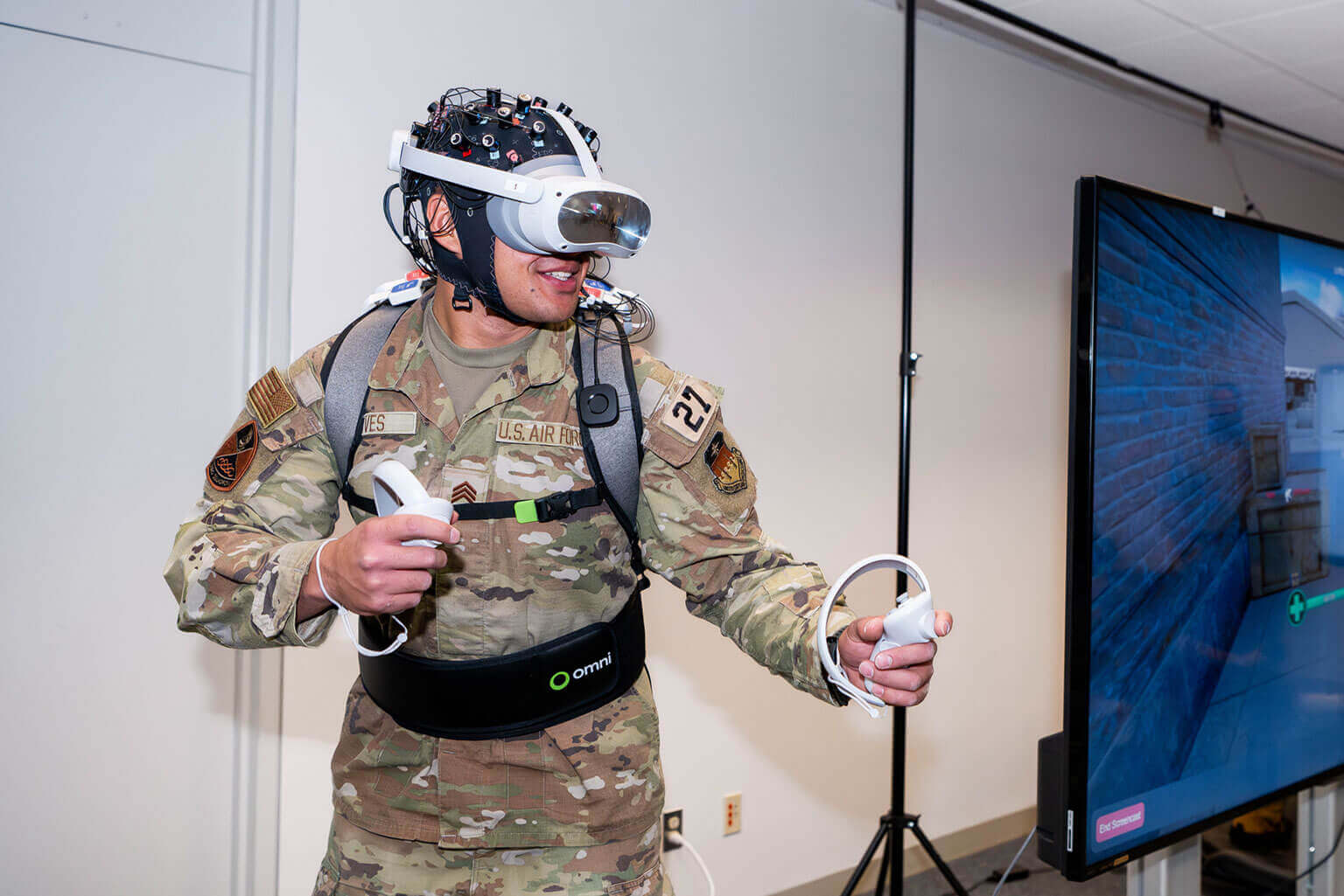 A cadet in a virtual reality headset, immersed in a training environment within a room.